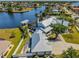 Overhead shot of waterfront home, boat lift and beautifully landscaped yard with mature trees at 310 Severin Se Rd, Port Charlotte, FL 33952