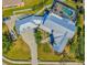 Aerial view of property highlighting the unique roofline, meticulous landscaping, and driveway at 310 Severin Se Rd, Port Charlotte, FL 33952