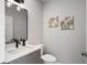 Chic half bath with modern black fixtures and stylish leaf decor at 310 Severin Se Rd, Port Charlotte, FL 33952