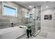 Stylish bathroom featuring a soaking tub, glass-enclosed shower, and modern fixtures at 310 Severin Se Rd, Port Charlotte, FL 33952