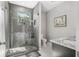 Stylish bathroom with a glass-enclosed shower, window view, and granite countertop at 310 Severin Se Rd, Port Charlotte, FL 33952