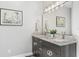 Bright bathroom with double sinks, granite countertop, and modern fixtures at 310 Severin Se Rd, Port Charlotte, FL 33952