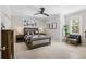 Well-lit bedroom with a window view, ceiling fan, and comfortable seating area at 310 Severin Se Rd, Port Charlotte, FL 33952