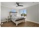 Cozy bedroom with queen-sized bed, wood floors, and abundant natural light at 310 Severin Se Rd, Port Charlotte, FL 33952