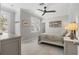 Bright bedroom with plantation shutters, a ceiling fan, and modern decor at 310 Severin Se Rd, Port Charlotte, FL 33952