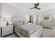 Elegant bedroom with a patterned bedspread, ceiling fan, and en-suite bathroom at 310 Severin Se Rd, Port Charlotte, FL 33952