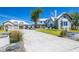 Stunning home exterior featuring a grand entrance, well-manicured landscaping, and a spacious driveway with ample parking at 310 Severin Se Rd, Port Charlotte, FL 33952