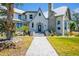 Attractive two-story home with stone accents, lush landscaping, and inviting entryway at 310 Severin Se Rd, Port Charlotte, FL 33952