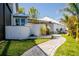 Professionally landscaped backyard with beautiful greenery, manicured lawn and a walking path, perfect for enjoying outdoor activities at 310 Severin Se Rd, Port Charlotte, FL 33952
