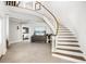 Grand foyer featuring a curved staircase, tile floors, and elegant decor at 310 Severin Se Rd, Port Charlotte, FL 33952