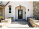 Stylish front entrance with stone steps, decorative lighting, and a modern door at 310 Severin Se Rd, Port Charlotte, FL 33952