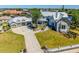 Charming front yard with lush landscaping, beautiful stone and siding accents, and a three-car garage at 310 Severin Se Rd, Port Charlotte, FL 33952