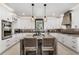 Spacious kitchen with white cabinets, granite countertops, stainless steel appliances, and a center island with seating at 310 Severin Se Rd, Port Charlotte, FL 33952