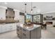 Spacious kitchen boasts modern white cabinets, a center island with granite, and a cozy dining area with fireplace at 310 Severin Se Rd, Port Charlotte, FL 33952
