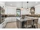 Beautiful kitchen featuring white cabinets, granite counters, stainless steel appliances and a center island with seating at 310 Severin Se Rd, Port Charlotte, FL 33952
