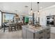 Open-concept kitchen with granite island, stainless appliances, and water views at 310 Severin Se Rd, Port Charlotte, FL 33952