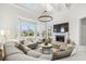 Bright living room featuring a fireplace, large windows, and comfortable seating at 310 Severin Se Rd, Port Charlotte, FL 33952