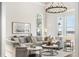 Spacious living room with large windows, chandelier, comfortable seating, and stylish decor at 310 Severin Se Rd, Port Charlotte, FL 33952