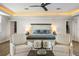 Stylishly furnished main bedroom with patterned rug, chairs, and ceiling fan at 310 Severin Se Rd, Port Charlotte, FL 33952