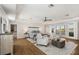 Spacious main bedroom featuring a tray ceiling, hardwood floors, balcony access, and a walk-in closet at 310 Severin Se Rd, Port Charlotte, FL 33952