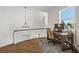 Home office space with a window view, modern desk, and chandelier at 310 Severin Se Rd, Port Charlotte, FL 33952