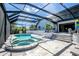 Inviting screened-in pool and hot tub area with a lanai, perfect for relaxation and enjoying the beautiful outdoors at 310 Severin Se Rd, Port Charlotte, FL 33952