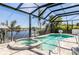 Enclosed lanai overlooking a sparkling pool and canal, offering a serene and private outdoor oasis at 310 Severin Se Rd, Port Charlotte, FL 33952