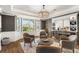 Inviting sitting area features custom bar with wine storage and statement lighting at 310 Severin Se Rd, Port Charlotte, FL 33952