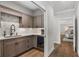 Chic wet bar featuring custom cabinets, a sink, backsplash, and a wine fridge at 310 Severin Se Rd, Port Charlotte, FL 33952