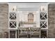 Stylish wine bar area with built-in storage, kitchen view, seating, and rustic wood accents at 310 Severin Se Rd, Port Charlotte, FL 33952