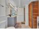 Bathroom with a shower, vanity and front loading washer and dryer behind partition at 312 Darst Ave, Punta Gorda, FL 33950