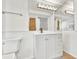 Clean bathroom with a mirrored wall, vanity, toilet, and shower visible in the reflection at 312 Darst Ave, Punta Gorda, FL 33950