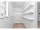 Clean, well-lit closet with multiple shelves for optimal storage and organization at 312 Darst Ave, Punta Gorda, FL 33950