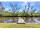 Waterfront property featuring a private wooden dock with access to a serene canal and lush greenery at 312 Darst Ave, Punta Gorda, FL 33950