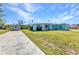 Charming blue house with a well-kept lawn and a shed, showcasing ample outdoor space at 312 Darst Ave, Punta Gorda, FL 33950