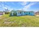 Quaint blue home featuring a well-maintained lawn, offering charm and curb appeal at 312 Darst Ave, Punta Gorda, FL 33950