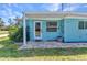 Welcoming front entrance featuring a brick paver patio and a bright blue facade at 312 Darst Ave, Punta Gorda, FL 33950