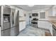 Open kitchen with stainless steel appliances, white cabinets, and eat-in area at 312 Darst Ave, Punta Gorda, FL 33950