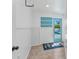 Bright laundry room with pool access, shelving, and a coastal-themed rug at 312 Darst Ave, Punta Gorda, FL 33950