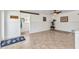 Living room featuring tile flooring, ceiling fan, and access to the mud room at 312 Darst Ave, Punta Gorda, FL 33950