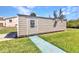 A well-maintained outbuilding with a concrete path surrounded by a green lawn at 312 Darst Ave, Punta Gorda, FL 33950