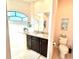 This bathroom features an elegant vanity with granite counters and walk-in shower at 3414 Sandpiper Dr, Punta Gorda, FL 33950