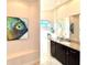 This bathroom features an elegant vanity with granite counters and a tiled shower at 3414 Sandpiper Dr, Punta Gorda, FL 33950