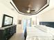 Spacious bedroom featuring a tray ceiling, a comfortable queen-sized bed, and access to a patio at 3414 Sandpiper Dr, Punta Gorda, FL 33950