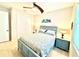 Cozy bedroom featuring a ceiling fan, tile floors, and a comfortable queen-sized bed with decorative artwork at 3414 Sandpiper Dr, Punta Gorda, FL 33950