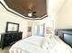 Bedroom featuring a tray ceiling, a comfortable queen-sized bed, dresser and access to a patio at 3414 Sandpiper Dr, Punta Gorda, FL 33950