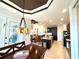 Open dining and kitchen area featuring an island, stylish pendant lights, and comfortable seating for entertaining guests at 3414 Sandpiper Dr, Punta Gorda, FL 33950