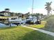 Several boats are docked on lifts on a waterfront property with a green lawn at 3414 Sandpiper Dr, Punta Gorda, FL 33950