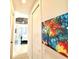 Hallway view of the primary bedroom features contemporary decor, light walls, and tile flooring at 3414 Sandpiper Dr, Punta Gorda, FL 33950