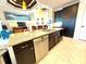 Kitchen island with seating, stainless steel appliances, granite counters, and dark cabinetry are shown in this modern interior at 3414 Sandpiper Dr, Punta Gorda, FL 33950